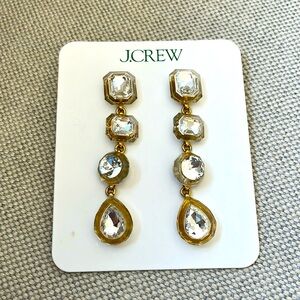 Long hanging earrings with gold and silver details.